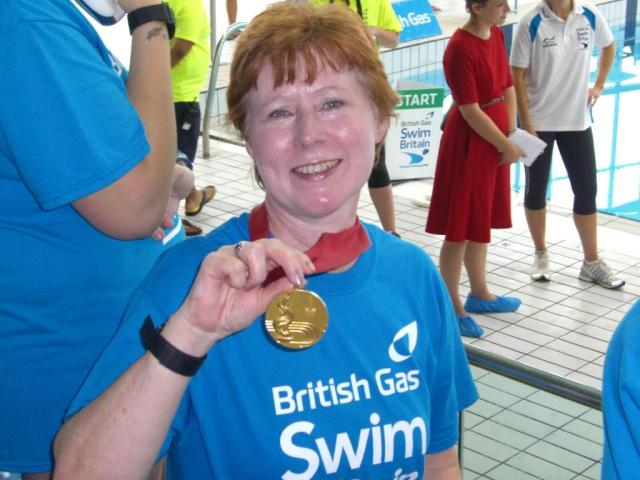 Sue Shepherd wearing Duncan Goodhew's Olympic gold medal